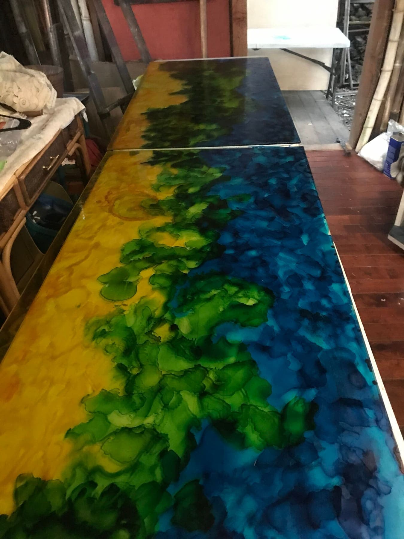 Yellow, green and blue alcohol ink glass panels before installation
